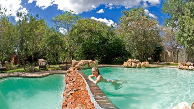 Sanctuary Chobe Chilwero; A guest enjoying the pool.