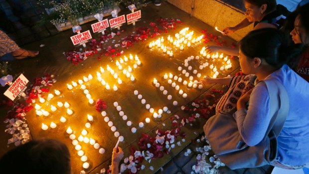 Human rights activists light candles in Quezon City for the victims of extra-judicial killings.