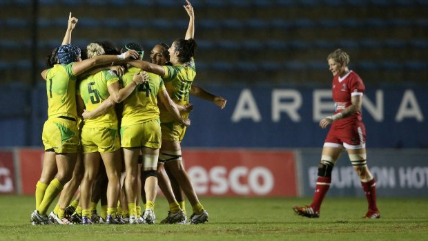 Sweet success: Australian players embrace after winning the final against Canada.
