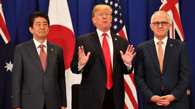 Malcolm Turnbull with US President Donald Trump and Japanese PM Shinzo Abe in Manila in November. China wants us to support their foreign policy objectives and cull us from the US alliance, Kim Beazley says. 