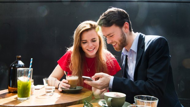 Happy app users: Housemates Kaitlyn Tremblay and Nicholas Phillpott having coffee in Barangaroo. 