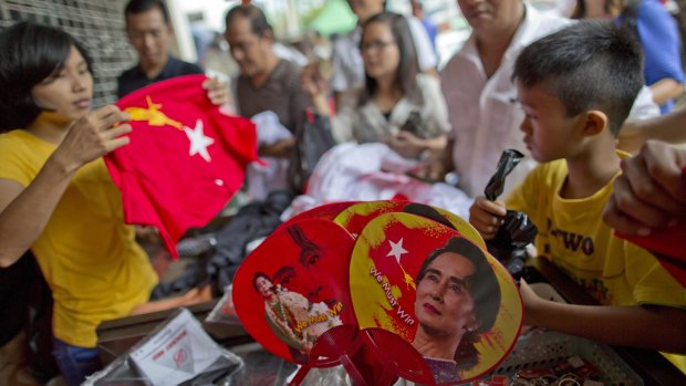 Buying merchandise with pictures of Myanmar opposition leader Aung San Suu Kyi on Tuesday at a shop run by her National League of Democracy party in Yangon.