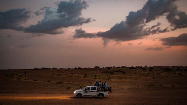 A ute with a bed full of people outside Agadez, Niger, which is a gateway to thousands of migrants on the way to Libya.