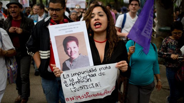 A woman shouts slogans holding a photo of Mexican journalist Miroslava Breach, gunned down in the northern state of Chihuahua.