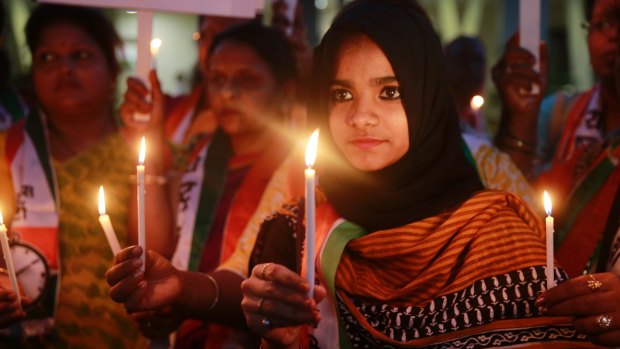 Activists hold lighted candles during a protest in Mumbai in 2015 over the release of a juvenile convicted in the 2012 fatal gang rape of a young woman aboard a moving bus.