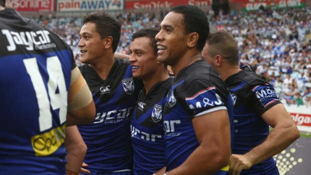 Dogs delighted: Chase Stanley, Sam Perrett and Will Hopoate celebrate Sam Perrett scoring a try during the round four NRL match between the South Sydney Rabbitohs and the Canterbury Bulldogs at ANZ Stadium.