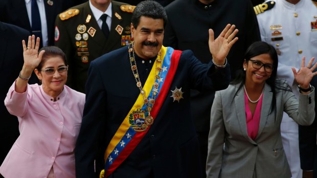 Venezuelan President Nicolas Maduro, centre, with his wife Cilia Flores, left, and Constitutional Assembly President Delcy Rodriguez wave as they arrive to the National Assembly on Thursday,