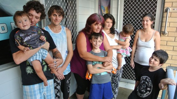 Lenore Lutanichi (centre) and her family at their Queensland housing commission house.