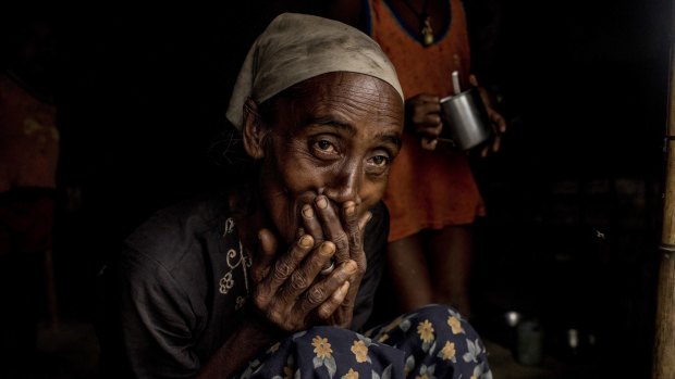 Feruza, a Rohingya refugee, watches rain fall at the improvised site she and others call "plastic camp" in Sittwe earlier this month. 