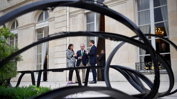 French President Emmanuel Macron, right, Paris Mayor Anne Hidalgo, left, and former mayor of New York City Michael Bloomberg talkat the Elysee Palace in Paris on Friday.