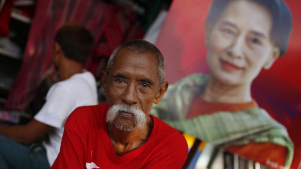 A supporter sits in front of a portrait of Aung San Suu Kyi in Mandalay, Myanmar, earlier this month. 