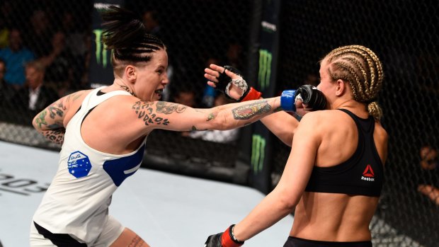 Bec Rawlings of Australia punches Paige VanZant of the United States.