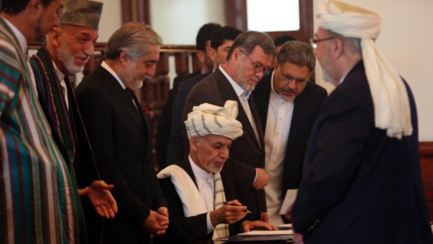 Afghan President Ashraf Ghani, centre, with Afghan chief executive Abdullah Abdullah third from left and former president Hamid Karzai second from left, signs the peace agreement with Gulbuddin Hekmatyar in September.