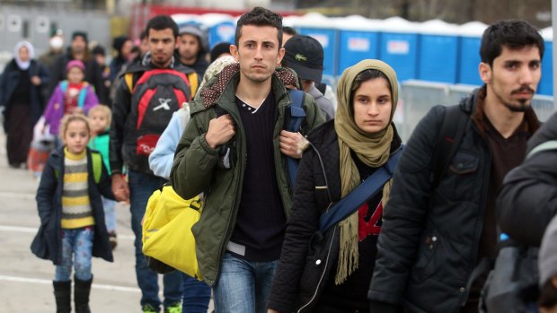 Migrants walk between registration tents at the border to Slovenia in Spielfeld, Austria, on Tuesday. 