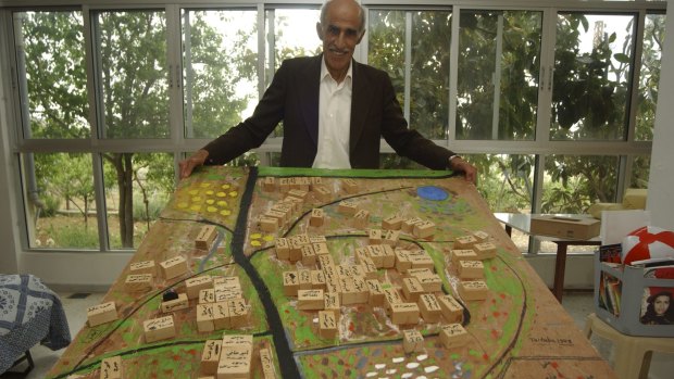Ahmad Saadi, a Palestinian refugee living in Lebanon, with a model of his home village of Taytaba in the Galilee, which he created from memory. Taytaba was depopulated in 1948 and remains derelict.