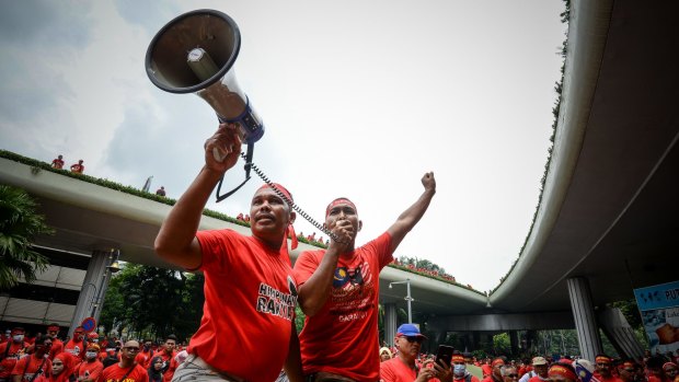 Pro-government "red shirt" protesters shout slogans during a demonstration in Kuala Lumpur earlier this month. 