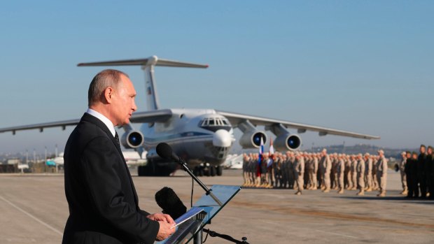 Russian President Vladimir Putin addresses the troops at the Russian-operated Hemeimeem air base in Syria on Monday.
