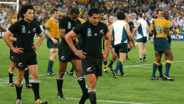 Semi-final anguish: New Zealand players leave the field as the Wallabies celebrate after the final whistle during the All Blacks' 22-10 loss to Australia in the 2003 tournament.