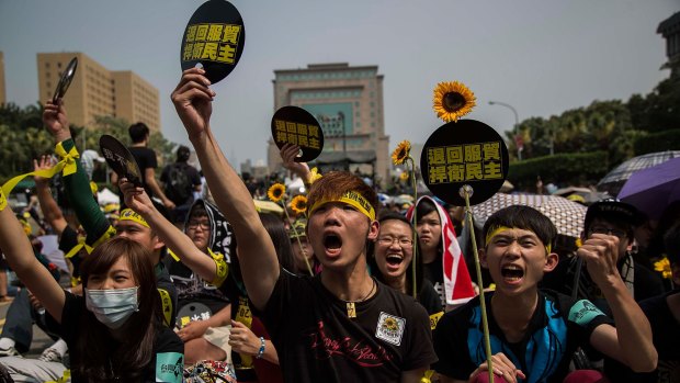 Protesters shout slogans during a rally called by the student groups occupying the legislature in Taiwan last year. 