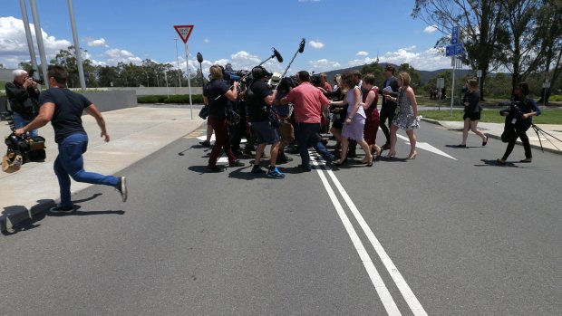 Senator Ricky Muir attempts to escape media attention outside Federal Parliament on Tuesday.