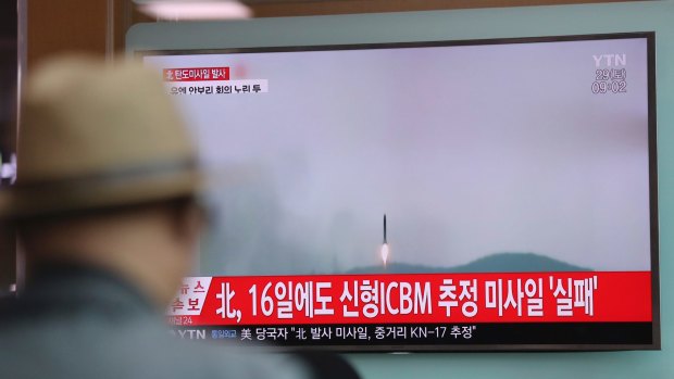 A man watches a TV news program reporting the North Korea's missile firing with a file footage, in Seoul, South Korea, on Saturday.