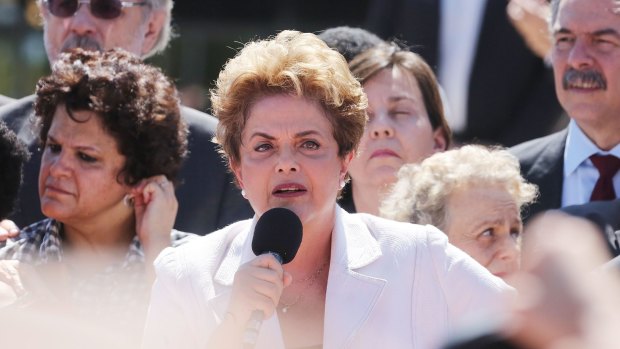 Dilma Rousseff (centre) speaks to supporters after being suspended on May 12.