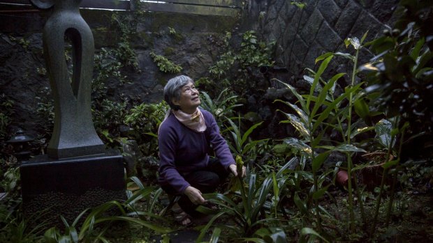 Guo Su-jen, whose father was executed during political repression in Taiwan in 1952, tending her garden in Taipei last month. 
