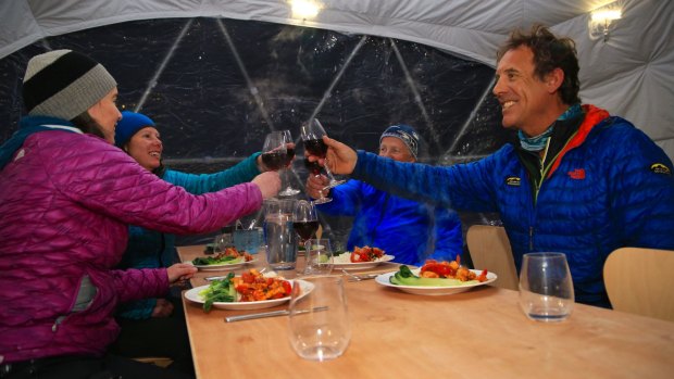 Inside the dome: Guy Cotter (right) and partner Suze Kelly (front left) raise a toast.