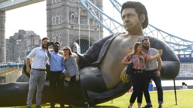 People take photos by a 25ft statue of actor Jeff Goldblum.