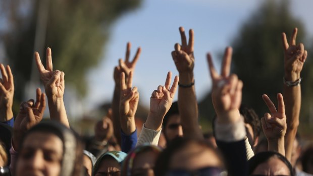 Mourners following the funeral procession for two victims of the Ankara bombing attacks, flash the V-sign in Izmir, Turkey, on Monday. 