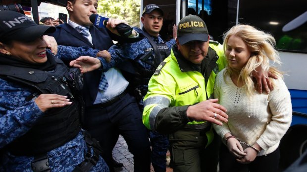 Police escort Cassie Sainsbury to an earlier court hearing in Bogota. She was sentenced to six years in prison. 