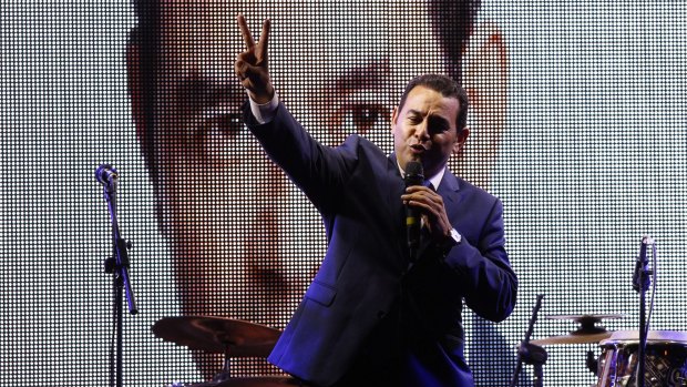 Former TV comedian and presidential candidate for the National Front of Convergence party, Jimmy Morales flashes a victory sign to his supporters in Guatemala City on Sunday.