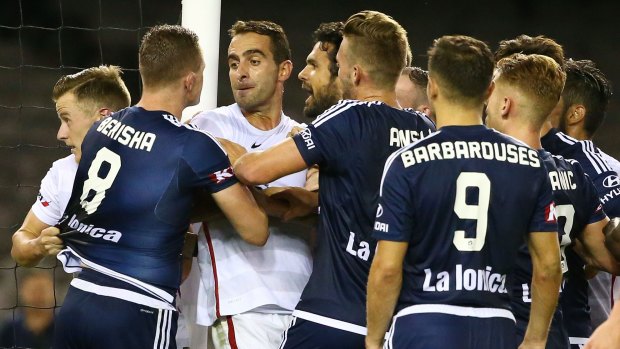 Stink: Alberto Aguilar saw red for his part in this stoush with Besart Berisha, but Popovic says the Victory man should have walked as well.