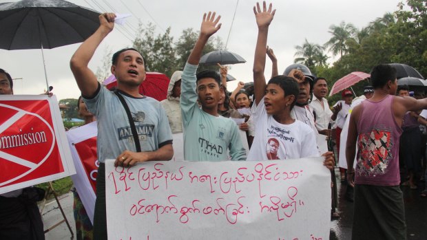 Demonstrators hold banners and shout slogans in protest of the arrival of Kofi Annan in Sittwe, Myanmar. 