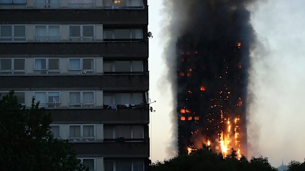 Smoke and flames rise from the tower early on Wednesday.