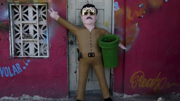 A pinata depicting the drug lord Joaquin 'El Chapo' Guzman outside a workshop in Reynosa in July.