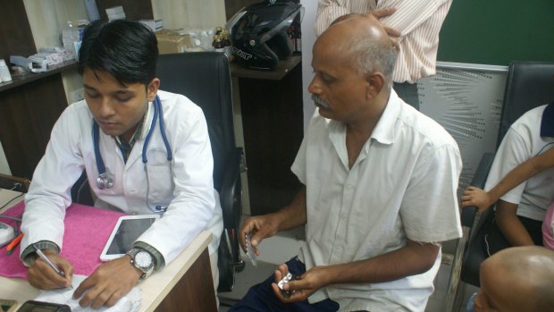 Dr Shoebul Haque prescribes medicines for diabetic Suresh Prasad.
