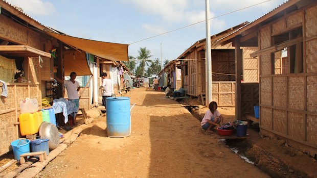 Temporary thatched huts outside Tacloban are modest, but cooler than the notorious "bunkhouses" in town.