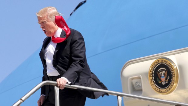 All tied up: President Donald Trump arrives at Orlando International Airport on Friday.