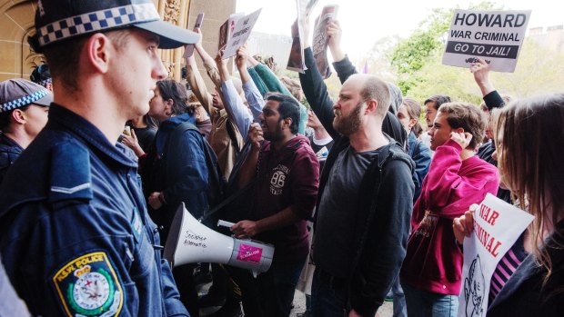 John Howard was greeted by protesters and a few supporters at the ceremony.