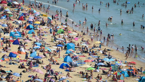 Tourists flock to the beach in Bournemouth, England, earlier this month. British citizens have expressed anger over having to self-isolate upon return from France and Spain due to COVID-19.