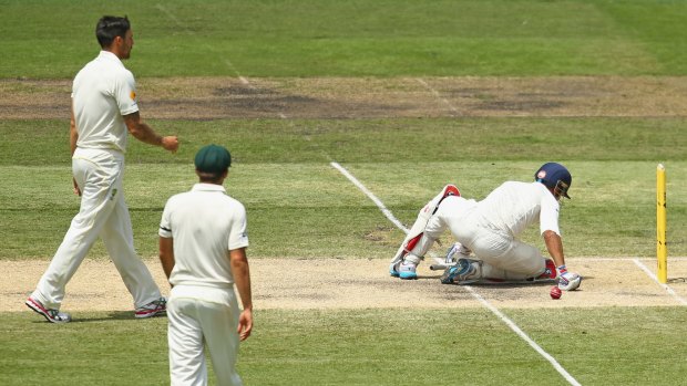 Man down: Virat Kohli falls to the ground after being hit by a throw from Mitchell Johnson during the Boxing Day Test.