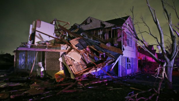 "Total devastation": Debris lies on the ground near a home that was heavily damaged by a tornado in Rowlett, Texas.