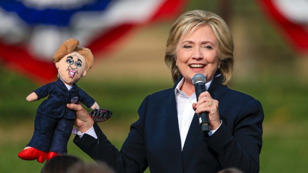 Hillary Clinton holds up a doll that was handed to her from the audience this week at a campaign stop in Council Bluffs, Iowa. 