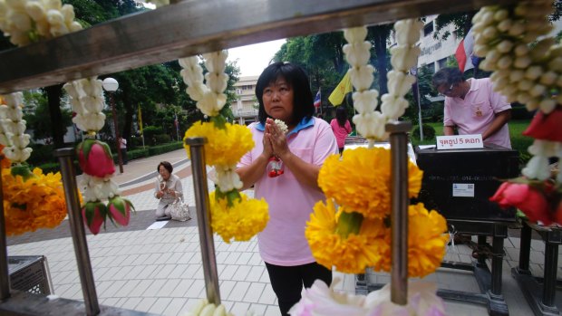 A woman prays at Siriraj Hospital where Thai King Bhumibol Adulyadej is being treated in Bangkok.