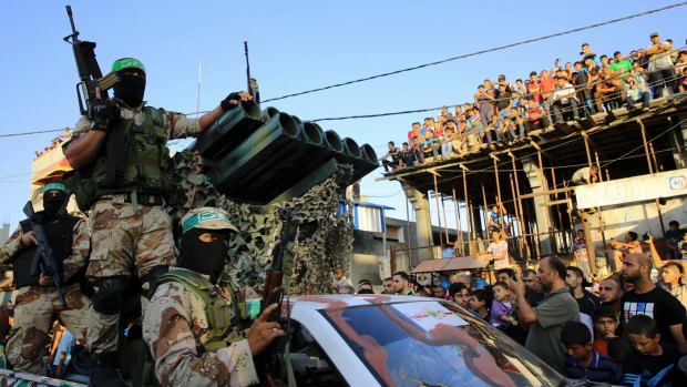 Palestinian members of the Izzedine al-Qassam Brigades, the armed wing of Hamas,  during a rally in the Rafah refugee camp in the Gaza Strip in August 2016.