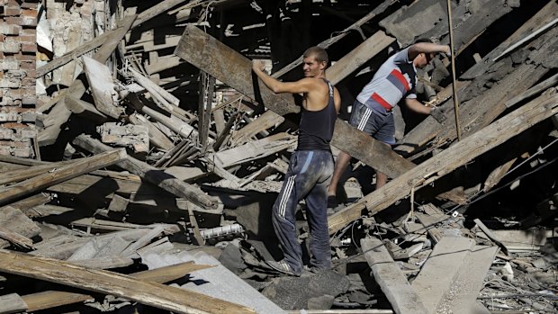 Residents sort through rubble in the town of  Ilovaisk, eastern Ukraine.