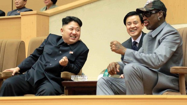 North Korean leader Kim Jong-un, left, talks with former NBA player Dennis Rodman, right, as they watch an exhibition basketball game at an indoor stadium in Pyongyang in 2014.