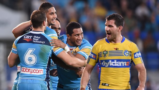 All smiles: Nene MacDonald and the Titans celebrate a try against the Eels.