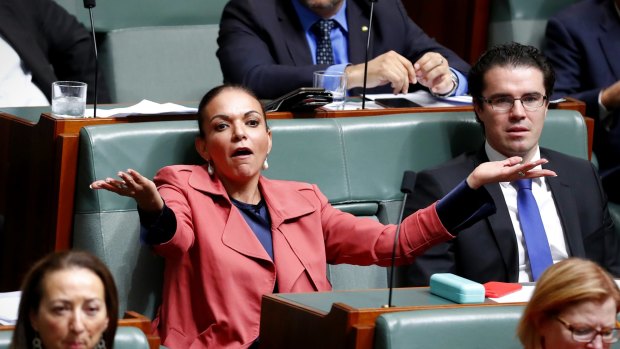 Labor MP Anne Aly listens to Immigration Minister Peter Dutton during question time on Thursday.